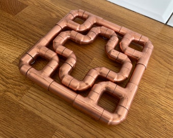 Salvamanteles doble de tubo de cobre 2 en 1 con diseño de cruz