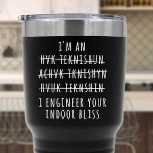 May include: Black insulated tumbler with a silver rim and lid. The tumbler features white text that reads "I'M AN HVK TEKNISHUN... I ENGINEER YOUR INDOOR BLISS."