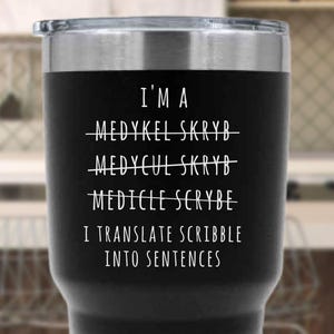 May include: Black insulated tumbler with a silver rim and lid. The tumbler features white text that reads "I'M A MEDYKEL SKRYB, MEDYCUL SKRYB, MEDICLE SCYBE, I TRANSLATE SCRIBBLE INTO SENTENCES."