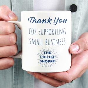May include: White ceramic mug with blue text that reads "Thank You for Supporting Small Business The Phileo Shoppe".
