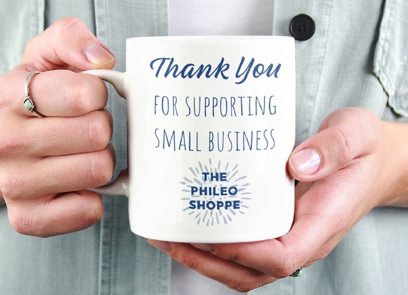 May include: White ceramic mug with blue text that reads "Thank You for Supporting Small Business The Phileo Shoppe".