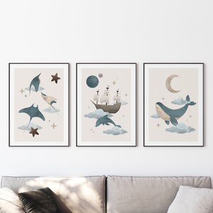 May include: Set of three framed prints with a nautical theme. The first print features a blue manta ray, the second print features a ship sailing on clouds, and the third print features a blue whale swimming on clouds.