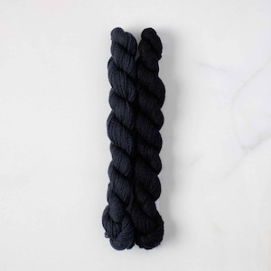 May include: Two skeins of black yarn, twisted together.