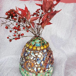 May include: A white ceramic mug with a black handle and the text "But First, Coffee" in a black, handwritten-style font. The mug is on a white surface.