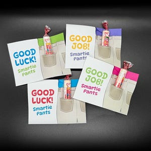 May include: A collection of small gift cards featuring a jeans pocket design, each containing a Smarties candy roll. The cards display phrases such as "Good Luck!" and "Good Job!", with the words "Smartie Pants" underneath.