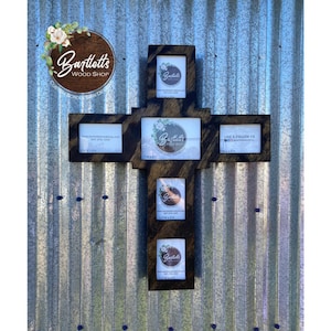 May include: A wooden cross with five picture frames, each with a brown wooden frame. The cross is stained dark brown and has the text "Bartlett's Wood Shop" on the top. The text "Like & Follow Us" is on the bottom right frame.