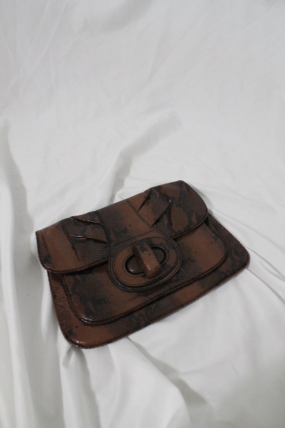 Snake clutch handbag