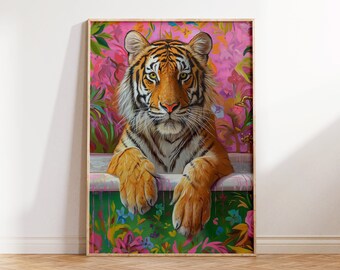 May include: A tiger with orange and black stripes sits in a bathtub with pink and green floral wallpaper. The tiger is looking directly at the viewer with its paws resting on the edge of the tub.