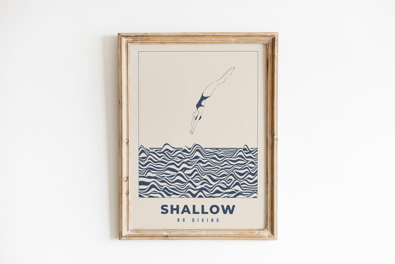 Op de afbeelding: Een ingelijste print met een minimalistisch ontwerp met een persoon die duikt in een blauw-wit golvend patroon. De tekst "SHALLOW NO DIVING" staat onderaan de print.