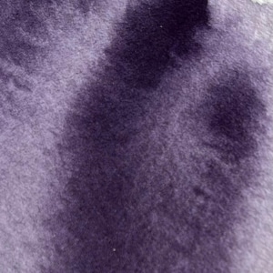 May include: Abstract close-up of a textured surface with a gradient of purple hues. The color transitions from a lighter lavender to a deep, dark violet, creating a soft, blurred effect. The texture appears plush and velvety.