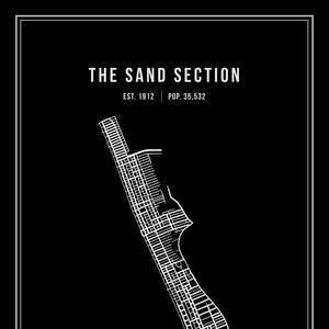 May include: A black and white map of The Sand Section, a neighborhood in California. The map shows the streets and blocks of the neighborhood. The text "THE SAND SECTION" is at the top of the map, with the text "EST. 1912 | POP. 35,532" below it.