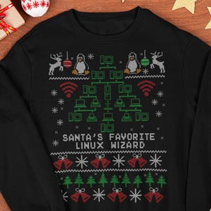 May include: Black sweatshirt with a festive design featuring reindeer, penguins, network diagrams, and the text "SANTA'S FAVORITE LINUX WIZARD." The design includes Christmas bells, trees, and snowflakes, perfect for the holiday season.