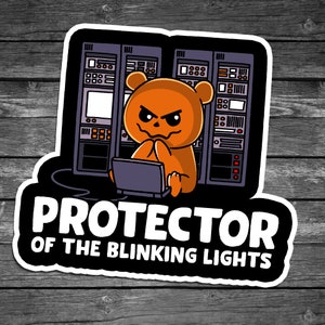 May include: A cartoon orange bear with a mischievous grin sits in front of a server rack with flashing lights. The text "PROTECTOR OF THE BLINKING LIGHTS" is written below the image.