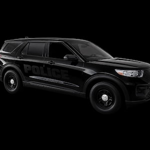 May include: A black Ford Police Interceptor SUV featuring a glossy finish, black steel wheels, and the word POLICE printed in large letters on the side door, with the word INTERCEPTOR displayed in smaller text directly underneath the main lettering.