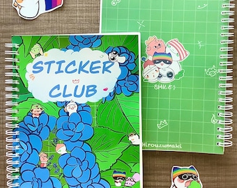 May include: Two spiral-bound notebooks with sticker designs. One notebook features blue floral art and the text "STICKER CLUB". The other is green with a grid pattern and cartoon stickers. Several sticker designs are scattered around the notebooks.
