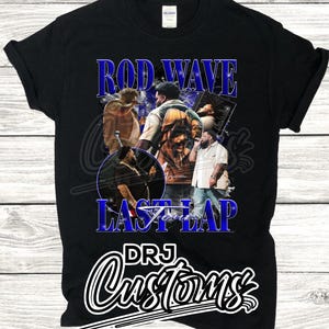 May include: Black t-shirt with a graphic of Rod Wave, a rapper, with the text "Rod Wave Last Lap" and "DRJ Customs" in blue and white lettering.