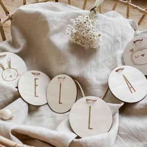 Name garland made from wooden discs punched or engraved