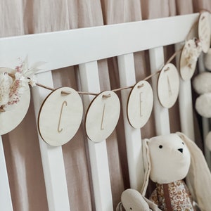 Name garland made of wooden discs with birth dates I dried flowers