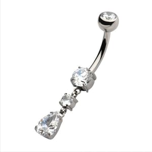 May include: A silver belly button ring with a dangling charm featuring three clear crystal stones.