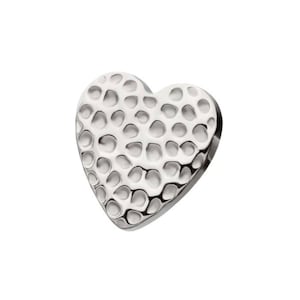 May include: A silver heart-shaped charm with a hammered texture.