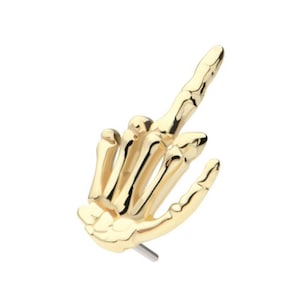 May include: Gold skeleton hand middle finger up body jewelry piercing