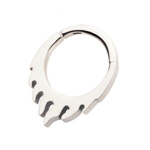 May include: Silver-toned stainless steel clicker earring with a drip design. The earring is a hoop with a hinged clasp.