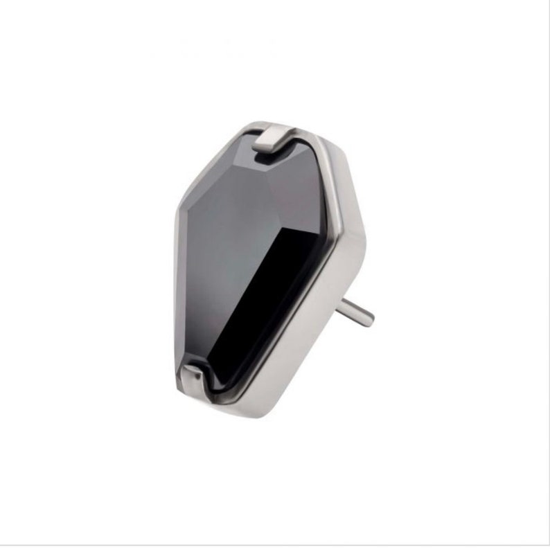 May include: A silver earring with a black gemstone in a geometric shape.