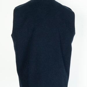 May include: A dark blue sleeveless sweater vest with a ribbed collar and a smooth texture.