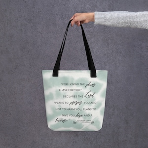 Peut inclure: Un sac fourre-tout avec un motif tie-dye vert et blanc. Le sac présente une citation de Jérémie 29:11, "Car je connais les projets que j'ai pour vous", déclare l'Éternel. "Des projets de paix et non de malheur, afin de vous donner un avenir et une espérance."