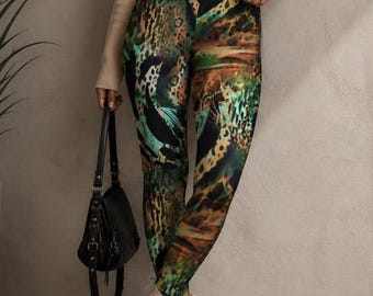 May include: A beige ribbed mock neck cropped sweater paired with high-waisted leggings featuring a multi-colored animal print in shades of green, black, and brown. The outfit includes a black handbag and beige platform ankle boots.