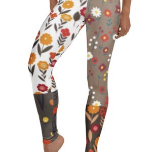 May include: A pair of leggings with a floral print. The leggings are split down the middle, with one side featuring a white background and the other side featuring a brown background. Both sides feature a variety of colourful flowers.