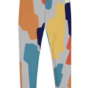 May include: Gray leggings with a colorful abstract print featuring shades of blue, orange, yellow, and red.