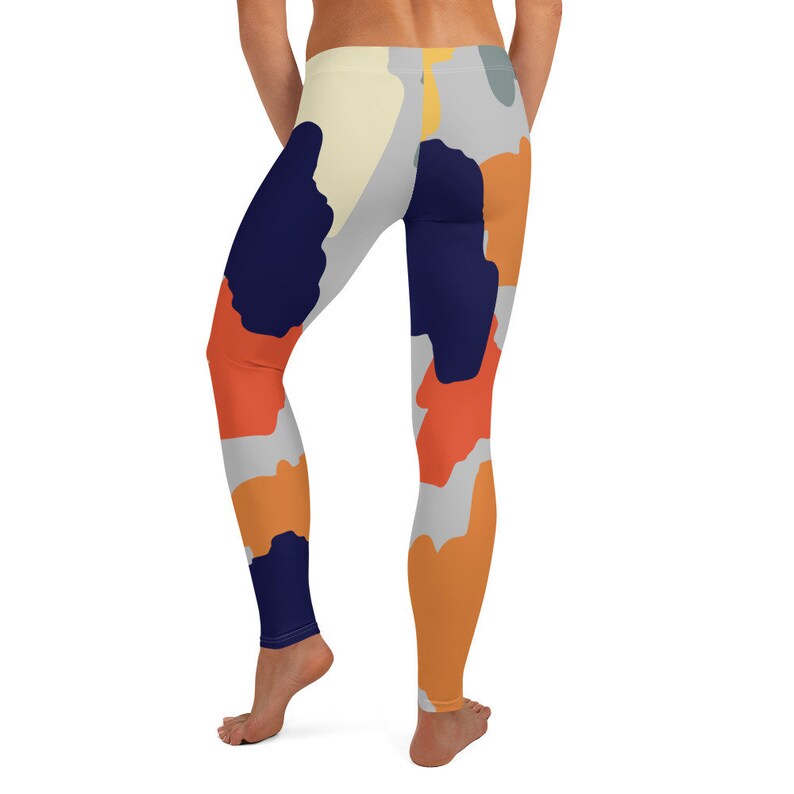 May include: A pair of leggings with a colorful abstract camouflage pattern. The leggings are made of a stretchy, comfortable fabric and feature a high waist.