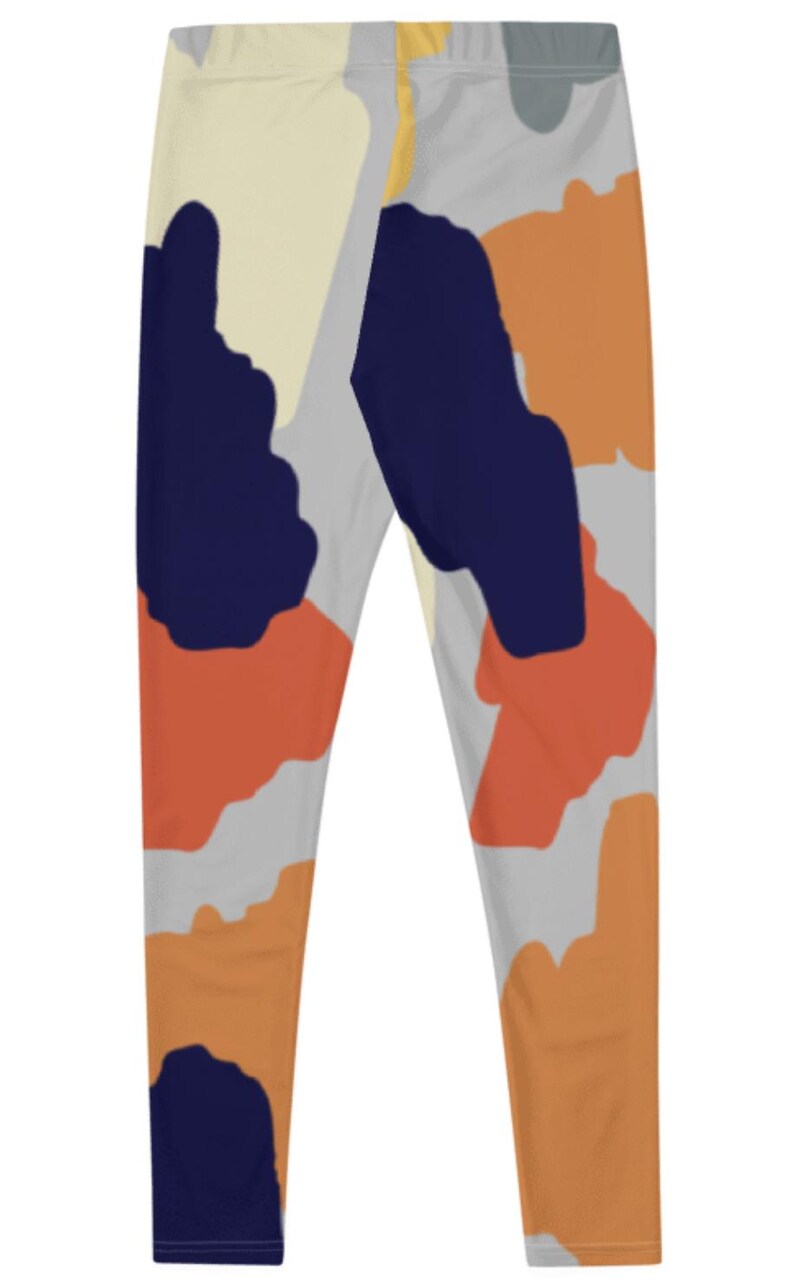 May include: A pair of leggings with an abstract print featuring shades of orange, blue, yellow, and gray.