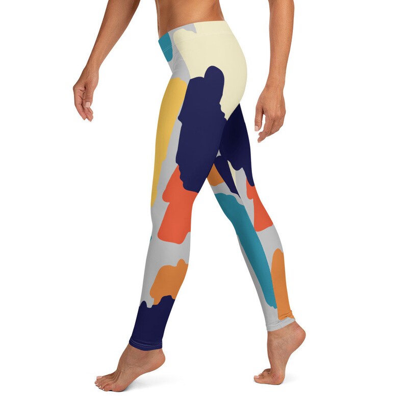 May include: A pair of leggings with a colorful abstract print featuring shades of blue, orange, yellow, and gray.