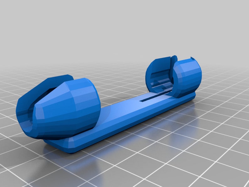 Puede incluir: Un organizador de cables de pl&aacute;stico azul con dos extremos redondos. El organizador est&aacute; dise&ntilde;ado para sujetar y asegurar los cables.