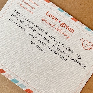 May include: A handwritten note on a textured card that says "Love gram special delivery". The note says "Note: I recommend using a felt-tip pen to write on the textured surface to ensure your text shows up! Ruth"