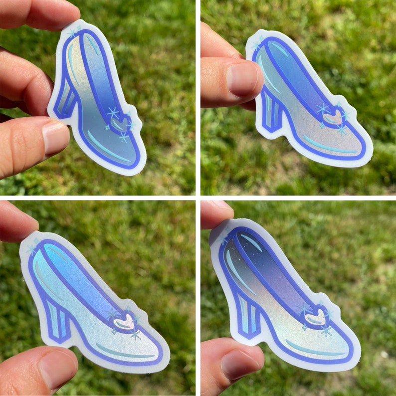 May include: Four glass slipper stickers with a blue iridescent finish. The stickers are shaped like a glass slipper and have a silver glitter design.