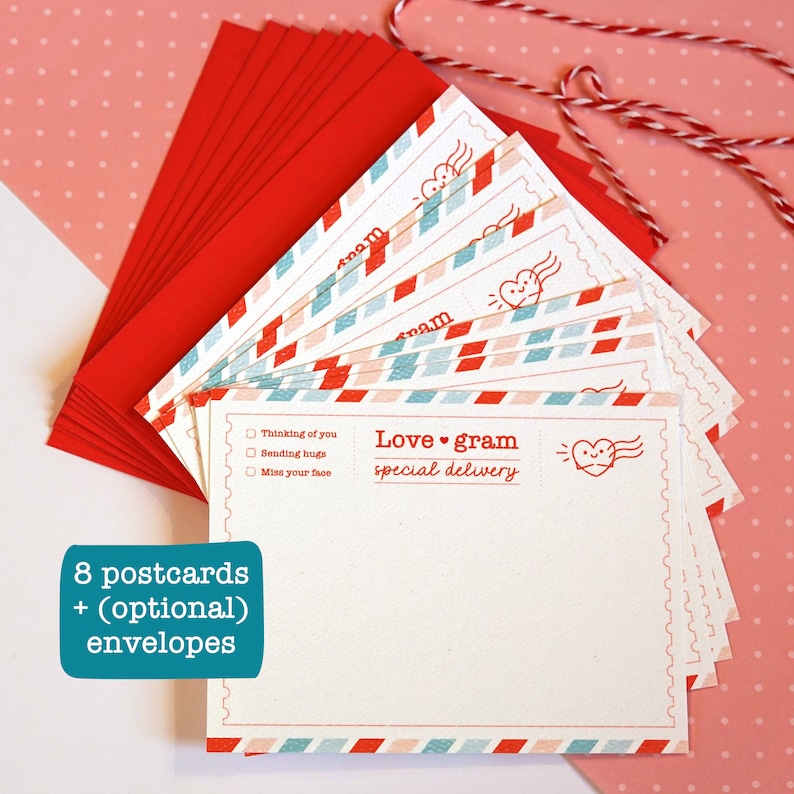 May include: A set of eight blank postcards with a red, white, and blue airmail pattern. The postcards have the text "Love gram special delivery" and a small heart with wings. The set also includes red envelopes.