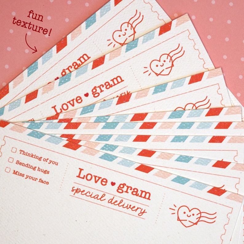 May include: A stack of colorful love gram cards with a red heart and the text "Love gram special delivery" on the front. The cards have a fun, textured design.