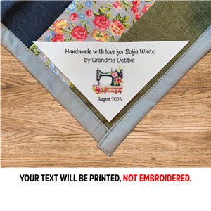 May include: A white ceramic mug with a black handle and the text "But First, Coffee" in a handwritten style. The mug is on a white surface. The mug is approximately 10 cm tall.