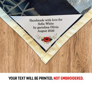 May include: A personalized, handmade item with a white label featuring text: "Handmade with love for Sofia White by garndma Olivia Augest 2026." The item has a floral design and is bordered by a cream-colored fabric. The bottom text reads: "YOUR TEXT WILL BE PRINTED, NOT EMBROIDERED."