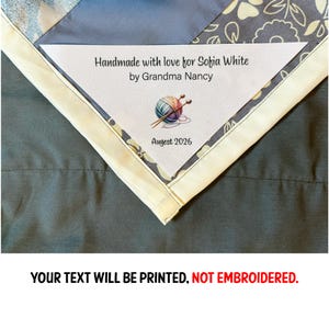 May include: A white label with the text "Handmade with love for Sofia White by Grandma Nancy" and a graphic of yarn and knitting needles. The label also includes the date "Augest 2026". The label is on a quilt with a floral pattern.