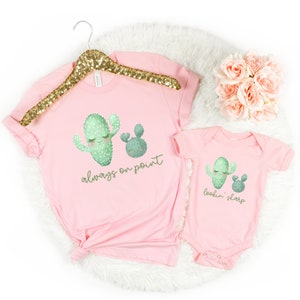 May include: Pink t-shirt and onesie set with a cactus graphic. The t-shirt says "always on point" and the onesie says "lookin' sharp".