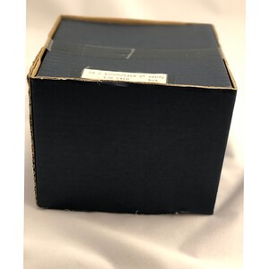 May include: A brown cardboard box with a white label that reads "PR - 10W/0/1438 6" candy box 130 1438".