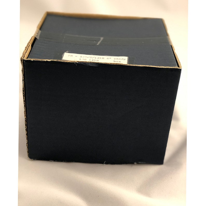 May include: A brown cardboard box with a white label that reads "PR - 10W/0/1438 6" candy box 130 1438".