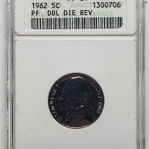 May include: A 1962 US 5c coin graded PF64 by ANACS with the label "PF DBL DIE REV". The coin is encased in a clear plastic slab with a white background.