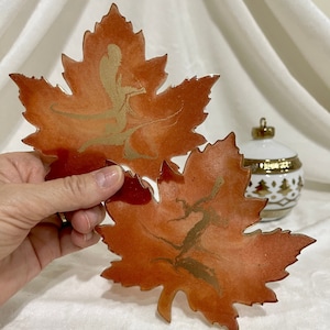 Beautiful Autumn maple leaf shaped gold, burnt orange and deep red coasters accented and edged in gold leaf