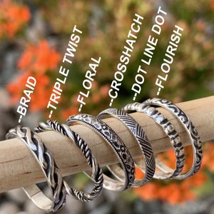 925 Sterling silver stacking rings in many sizes on a models hand. Cute dainty rings, midi, custom sizes, rings set, stackable real .925 silver. Patterns include leaves, vines, greek, hearts, twist, braded, snake, dots, place shiny silver, and more.