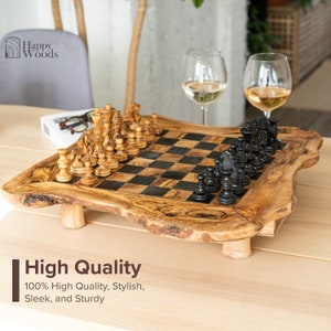 May include: A wooden chessboard with black and white squares, made from olive wood. The board has a natural, rustic look and is set on a wooden table. The chess pieces are made of wood and are arranged on the board in a starting position. The board has a natural, rustic look and is set on a wooden table. The chess pieces are made of wood and are arranged on the board in a starting position. The board has a natural, rustic look and is set on a wooden table. The chess pieces are made of wood and are arranged on the board in a starting position.